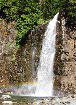 Waterfall with a rainbow at the base of it.